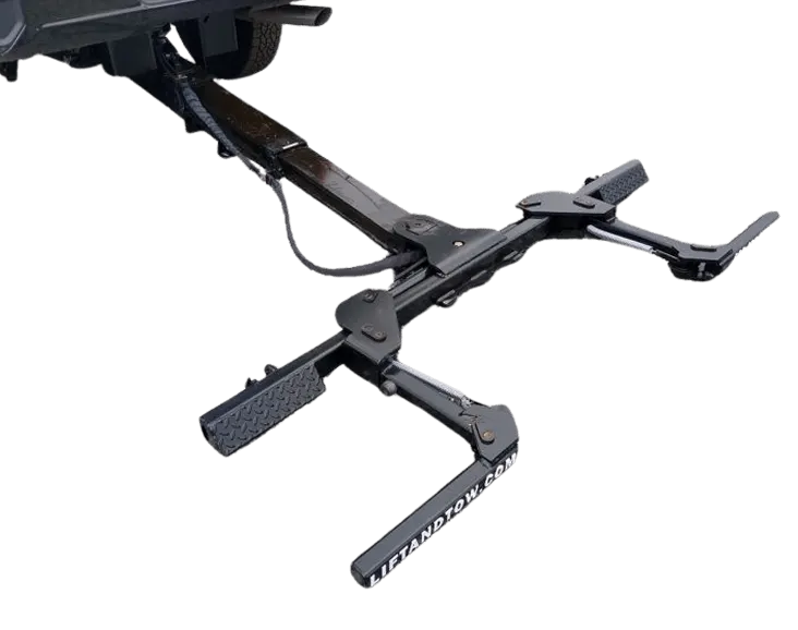 Lift & Tow Z-Series extended from beneath a pickup, with its tire cradles and L-arms visible