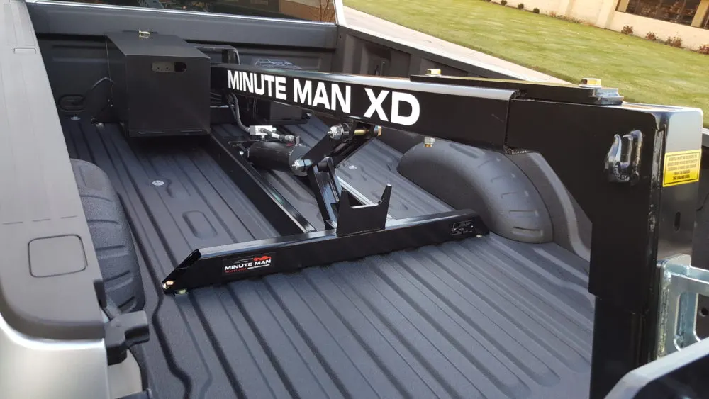 Minute Man XD wheel lift mounted in a pickup bed, with the optional steel pump cover shown
